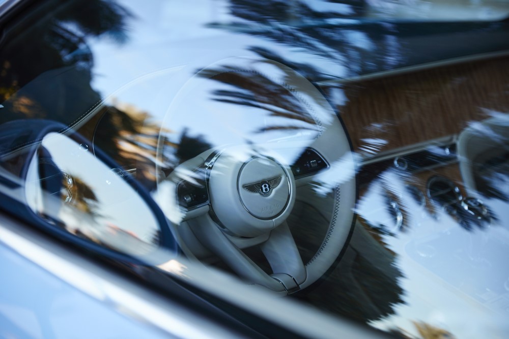 Luxury Bentley car steering wheel with white interior leather